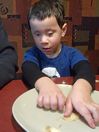 Makkyle Masek eating from a plate. 