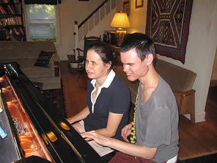 Heidi Musser and Justin sit at the piano.