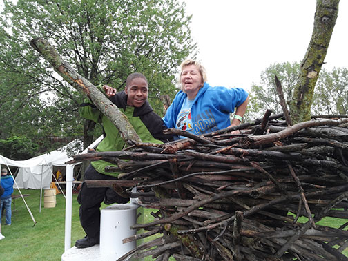 Donna Posont shows a boy a large bird&rsquo;s nest close to the ground.