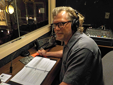 Martin Wilde sits in a booth describing a theater performance. Courtesy of Colette Martin-Wilde