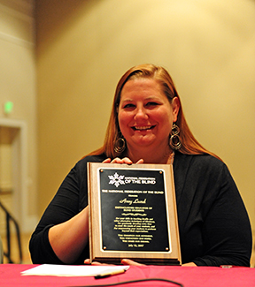 Amy Lund holds her award plaque.