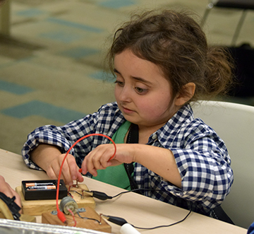 Julia Gebert conducts an experiment during NFB Youth Slam.