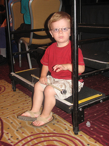 Chase Creer sits with his cane across his lap.